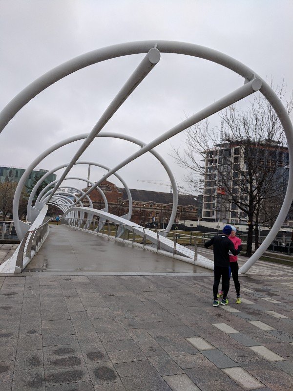 Bridge with two runners embracing